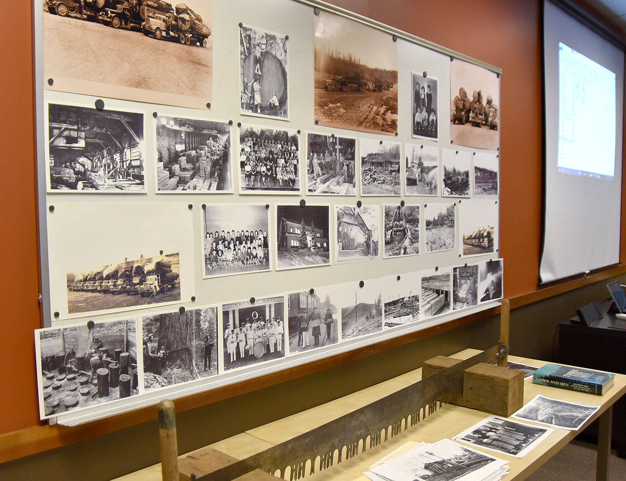 A display of historic photos drew many guests during the intermission. (Carol Ladwig/Staff Photo)