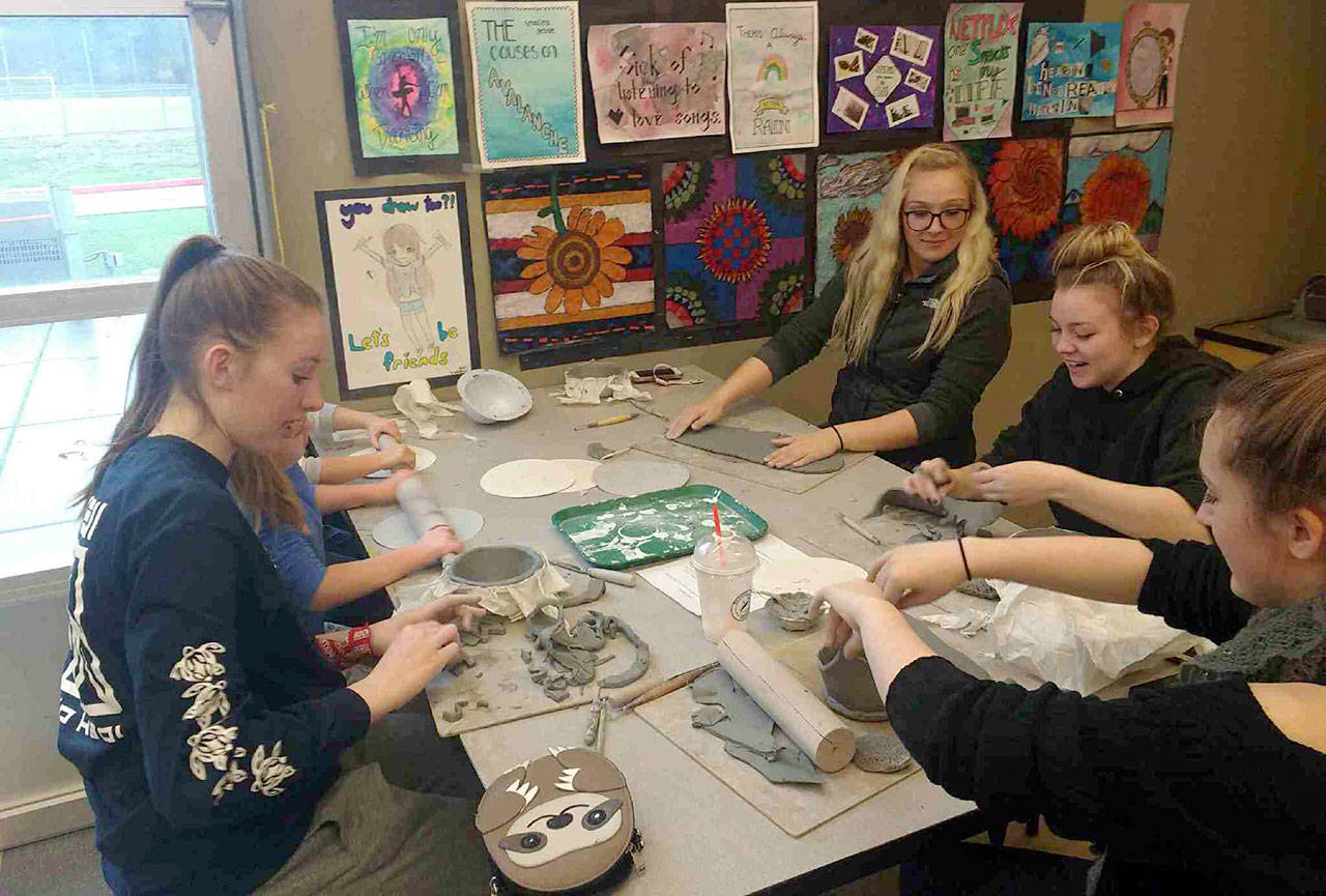 Mount Si High School’s cheer team works on making bowls for the Empty Bowls fundraising event, Dec. 8. (Courtesy Photo)