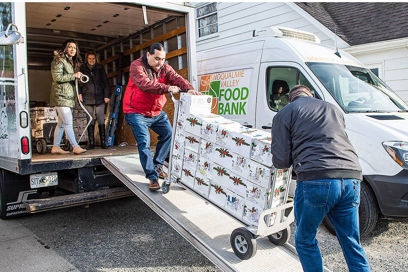 Volunteers unload a truck with donations of holiday hams for the Snoqualmie Valley Food Bank. (Photo courtesy of the Snoqualmie Tribe)