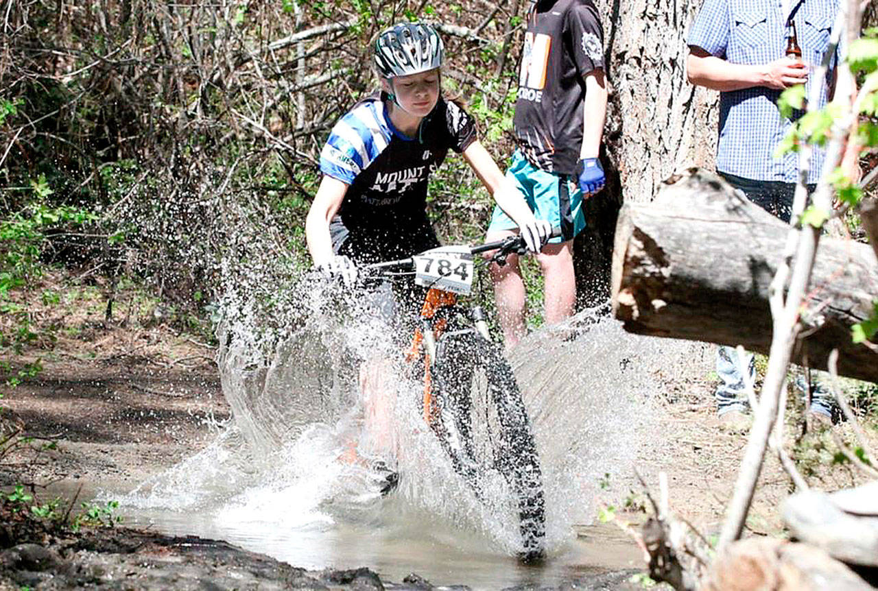 Ashley Collier races through a creek in a Student Cycling League event near Roslyn earlier this year. (Courtesy Photo)                                Ashley Collier races through a creek in a Student Cycling League event near Roslyn earlier this year. (Courtesy Photo)