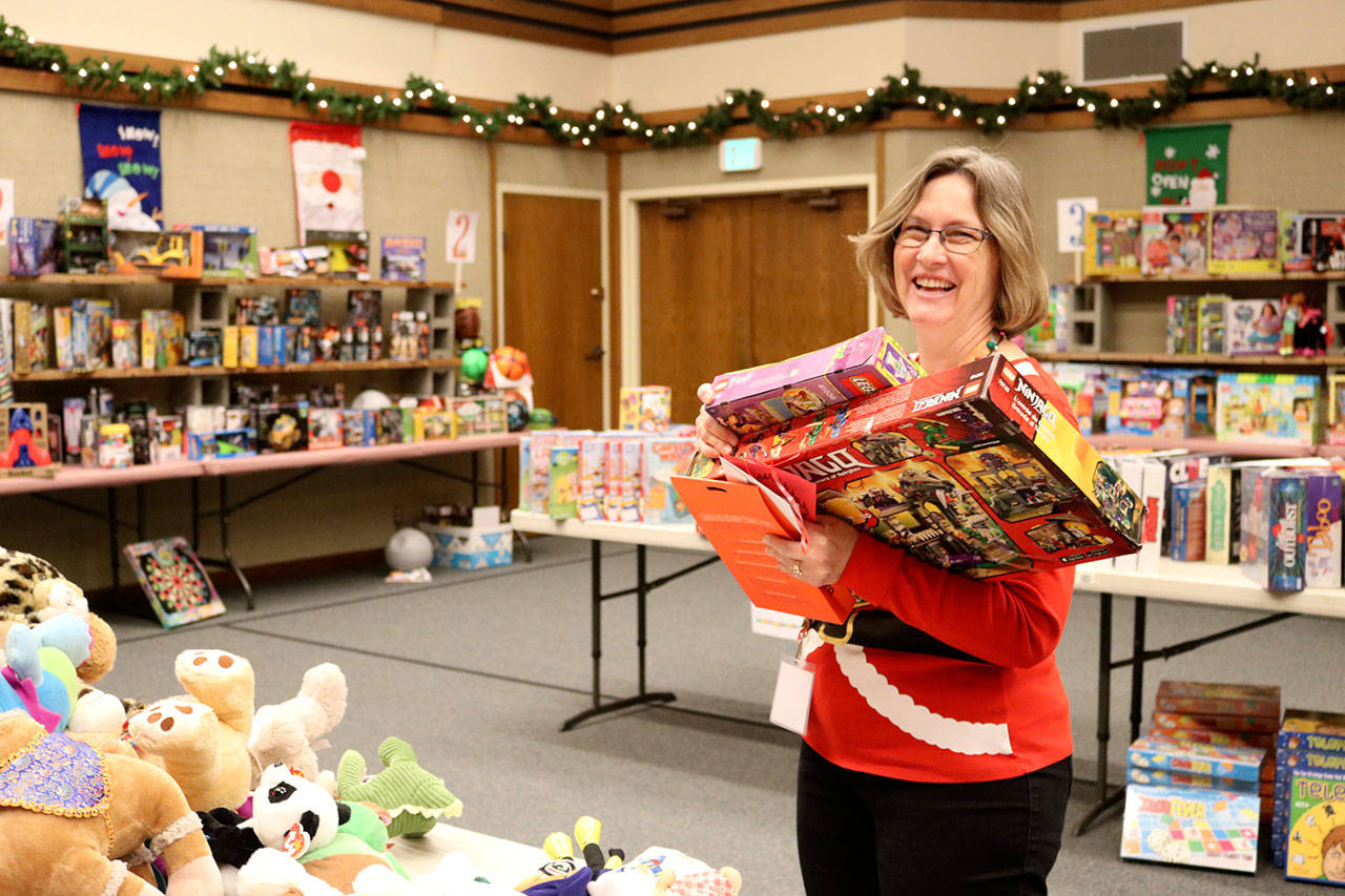 Diane Garding reorganizes some of the toys available at the North Bend Church of Jesus Christ of Latter-day Saints. (Evan Pappas/Staff Photo)