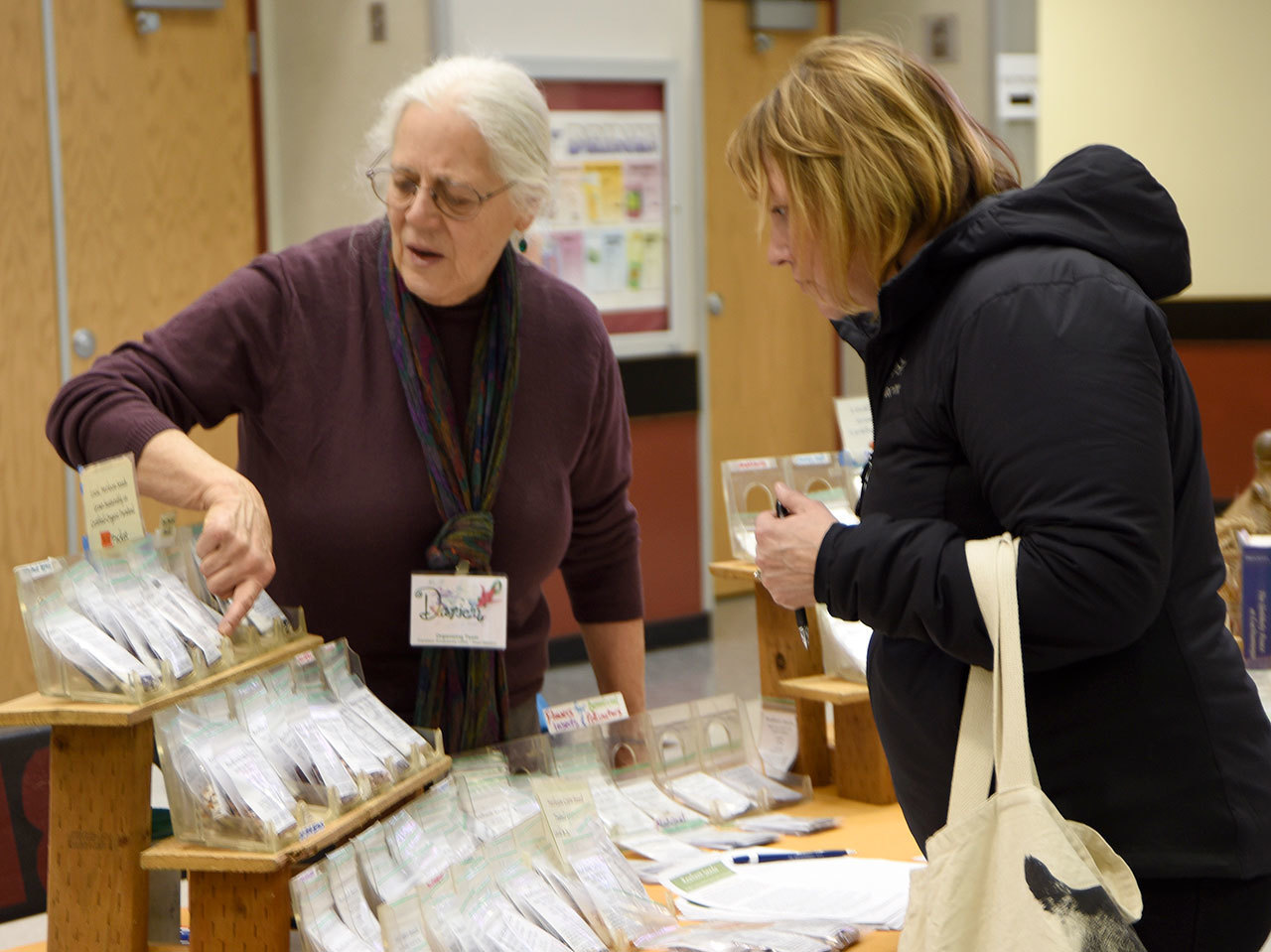 Darien Payne discusses various seeds with a participant in the 2017 Snoqualmie Valley Seed Exchange. The event returns to Cedarcrest High School Feb. 10.