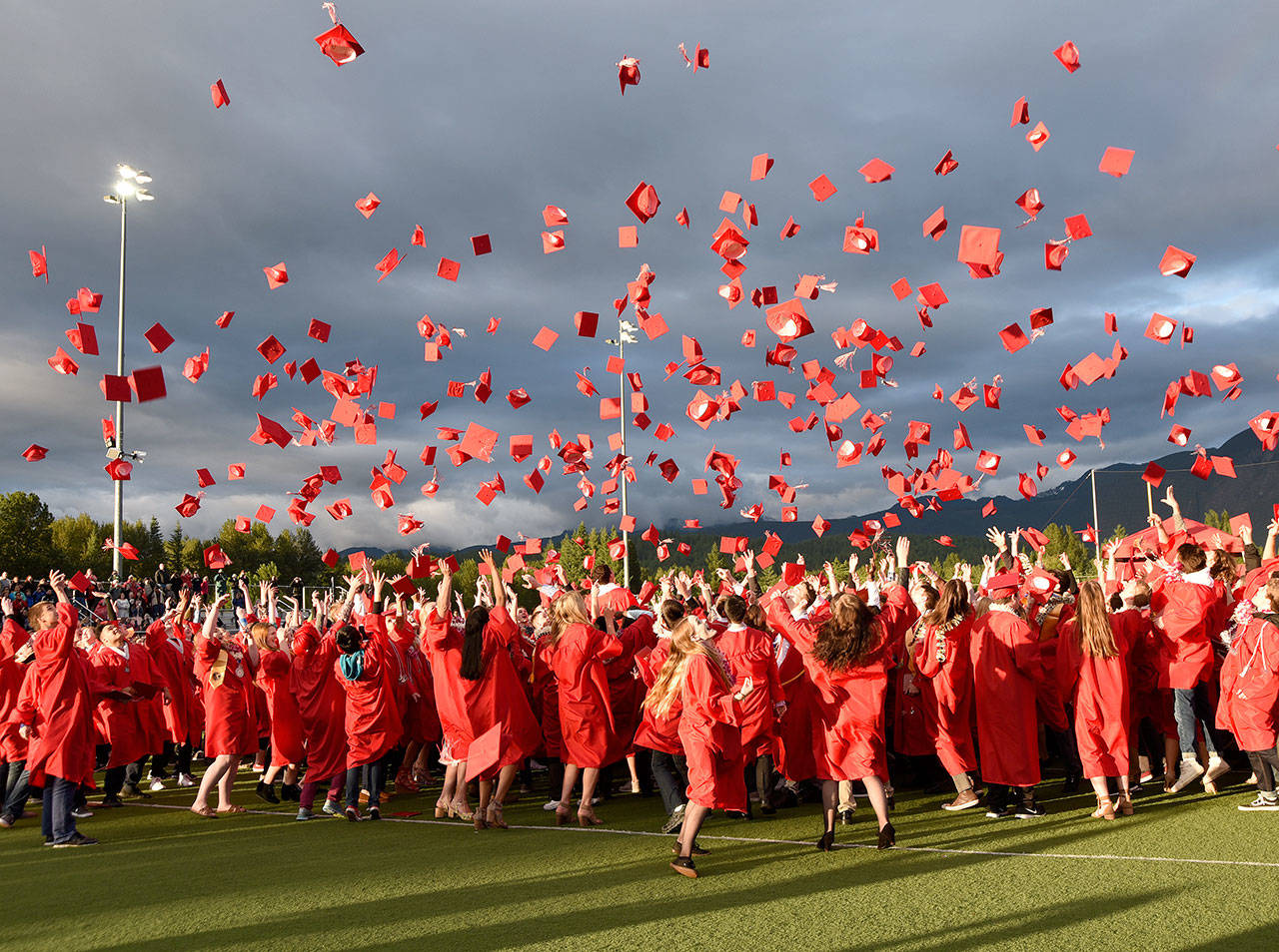 The Class of 2017, pictured celebrating with the traditional cap toss after commencement ceremonies at Mount Si Stadium, is the last class to graduate on the school’s football field. Because of capacity challenges during construction of the new high school and the growing class sizes and demand for tickets to the ceremony, the high school announced Dec. 18 that the 2018 commencement will be held in Kent. (Carol Ladwig/Staff Photo)