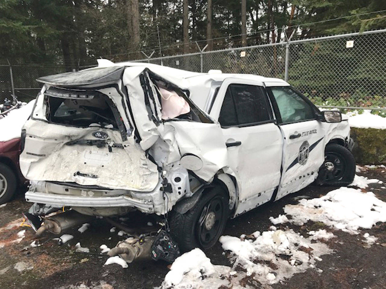 A distracted driver struck Washington State Patrol Trooper Michael Patoc’s vehicle while he was helping a disabled motorist blocking a lane of eastbound Interstate 90 on Tuesday night in Bellevue. (Photo courtesy of the Washington State Patrol)