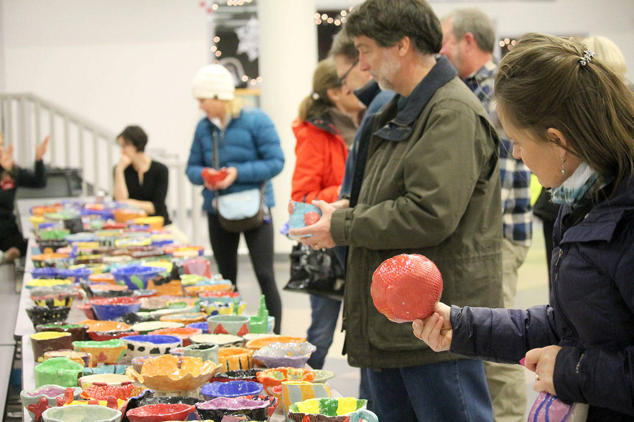 Attendees examine the hand-made bowls and decide which one they want to take home. (Courtesy photo)