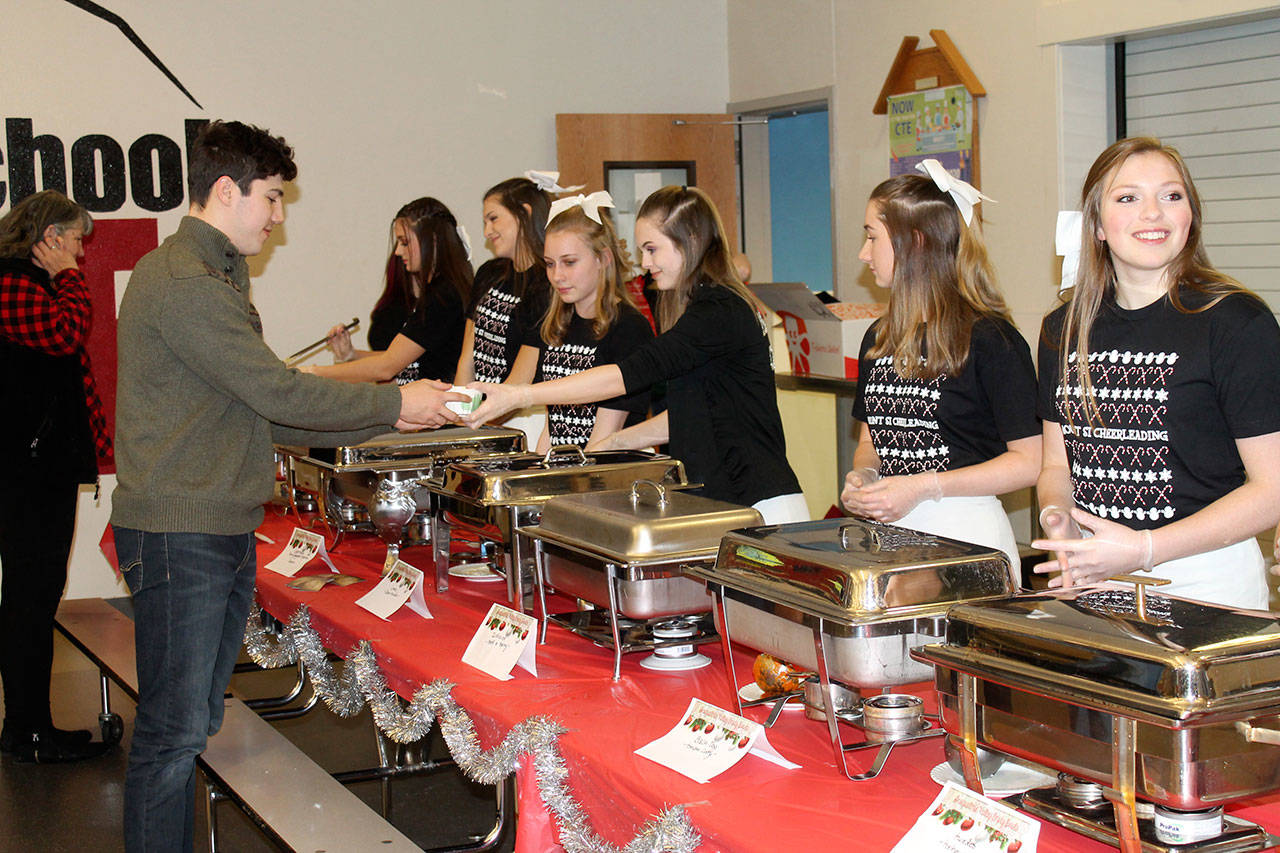 Members of the Mount Si Cheer Team serve soup to the people attending the community dinner. (Courtesy photo)