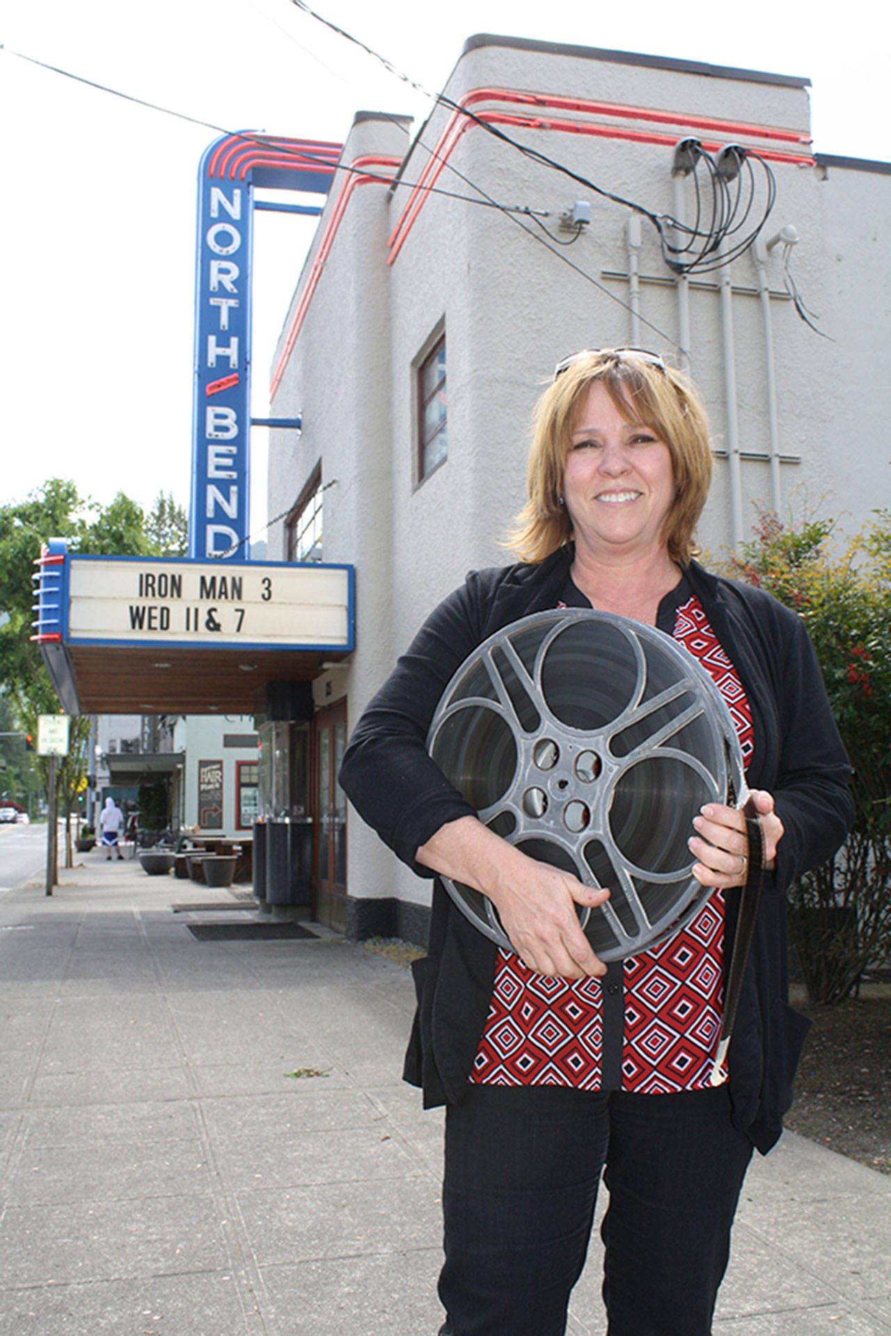 North Bend Theatre owner Cindy Walker is pictured here in 2013, as the theater prepared to fundraise for a digital projection transformation project. Through a community-supported crowdfunding project, the Walkers were able to raise $75,000 of the $100,000 cost of the transition. (Record file photo)