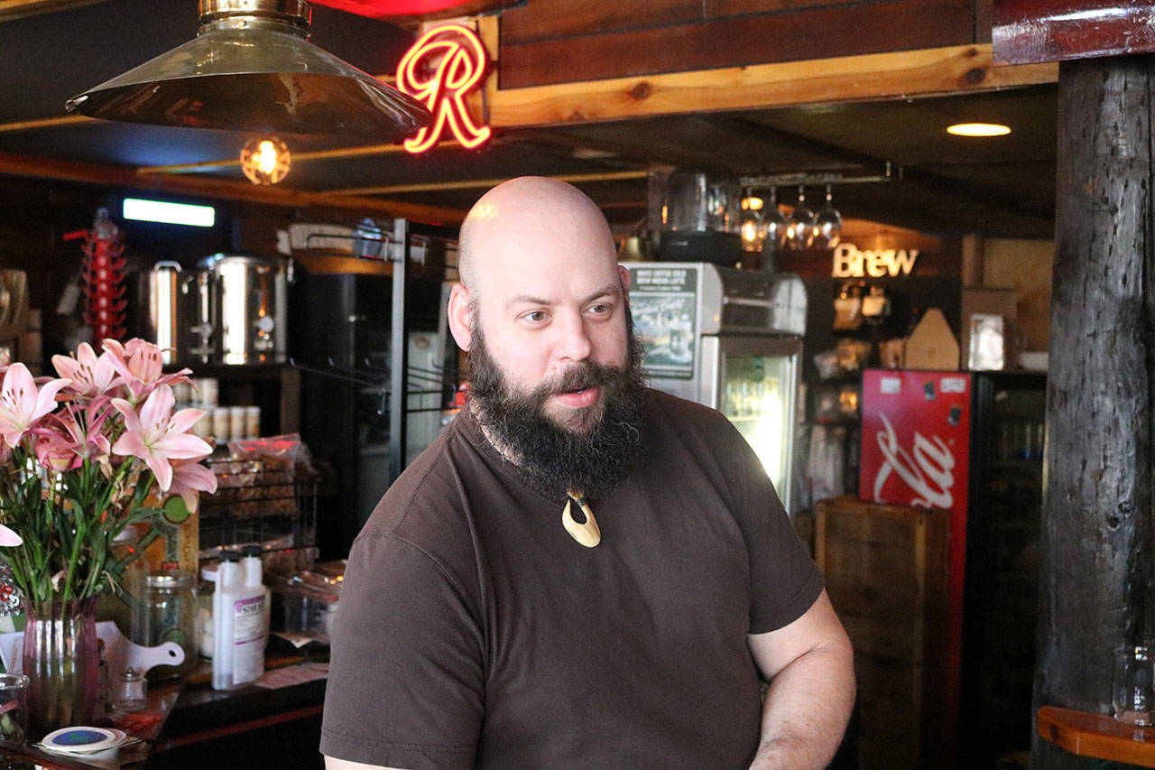 Chris Rohr stands behind the bar at Flood Valley Brewing. Rohr opened the brewery in recent years and hopes to help revitalize the local economy by becoming an anchor business in downtown Chehalis. Aaron Kunkler/Staff Photo