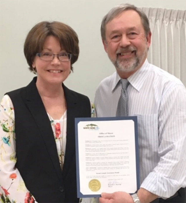 King County Sexual Assault Resource Center’s Laurel Redden poses with North Bend Mayor Ken Hearing after he proclaimed April as Sexual Assault Awareness Month. Photo courtesy of the city of North Bend