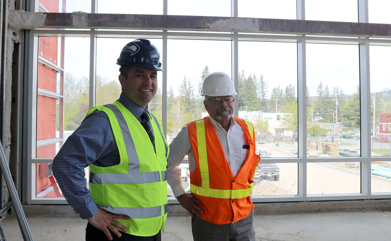 Assistant Superintendent Ryan Stokes and Project Manager Clint Marsh, discuss the pace of the project in one of the student gathering areas that has had the windows installed. Evan Pappas/Staff Photo