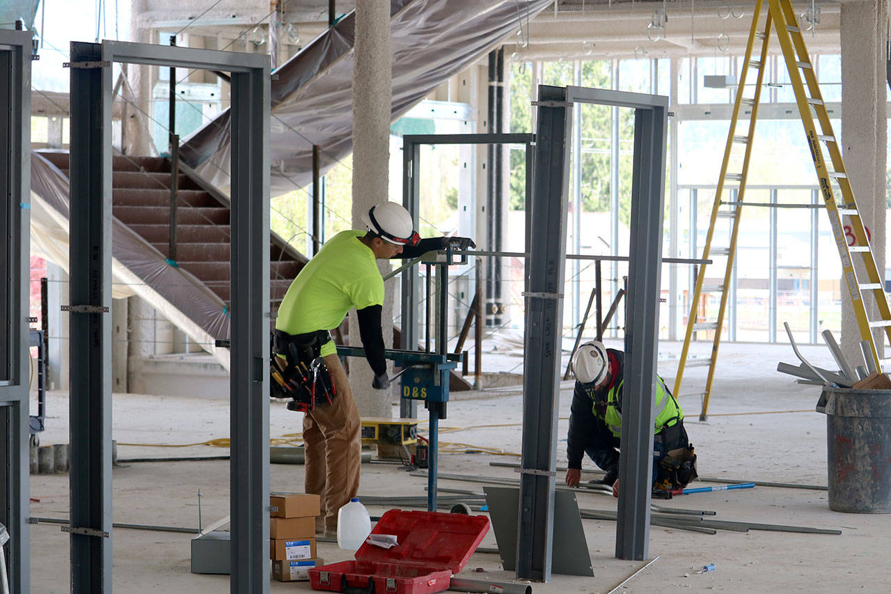 Construction crews work on door frames on the second floor of the building. Evan Pappas/Staff Photo