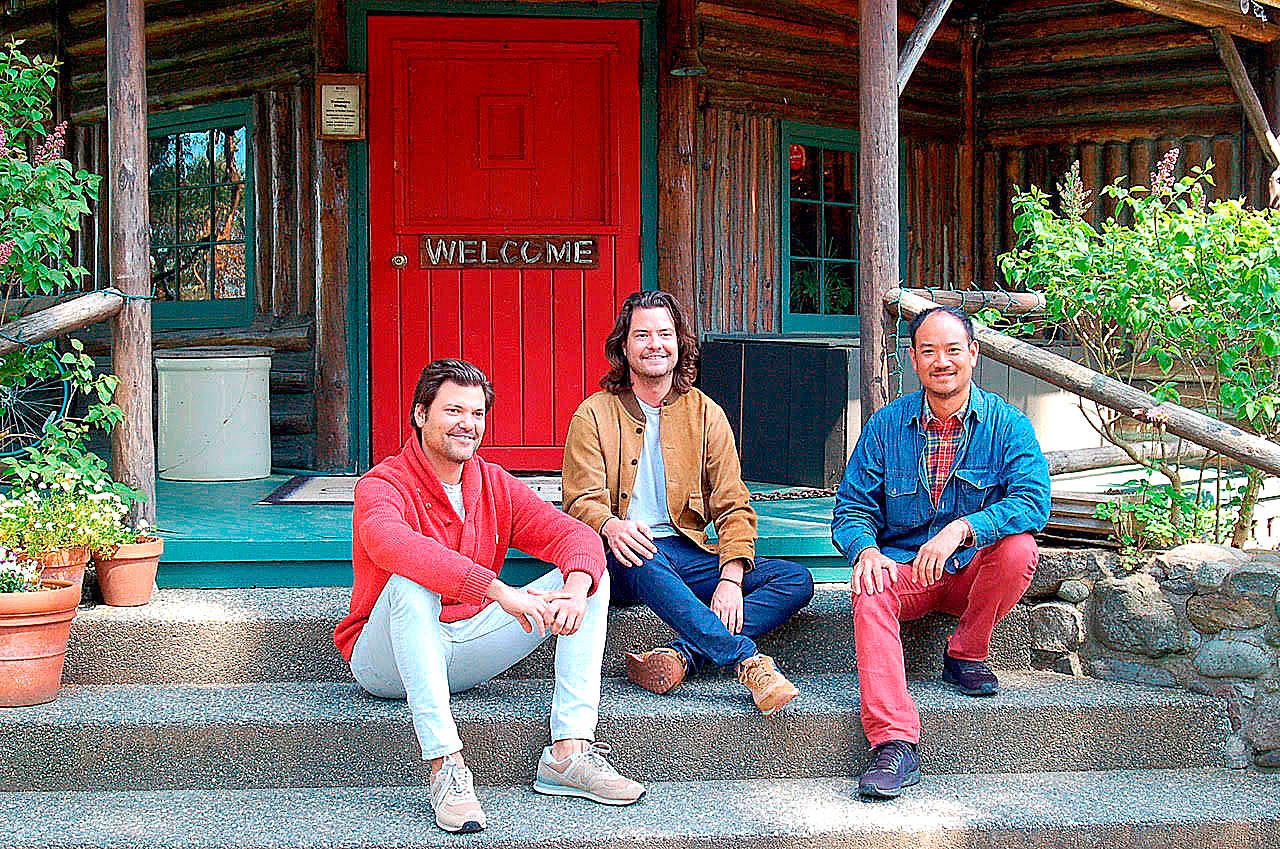 New owners of Central Whidbey’s historic Captain Whidbey Inn are, from left, Matt French, his brother, Mike, and Eric Cheong. The three take a break on the inn’s porch. (Photo by Rick Chapman)