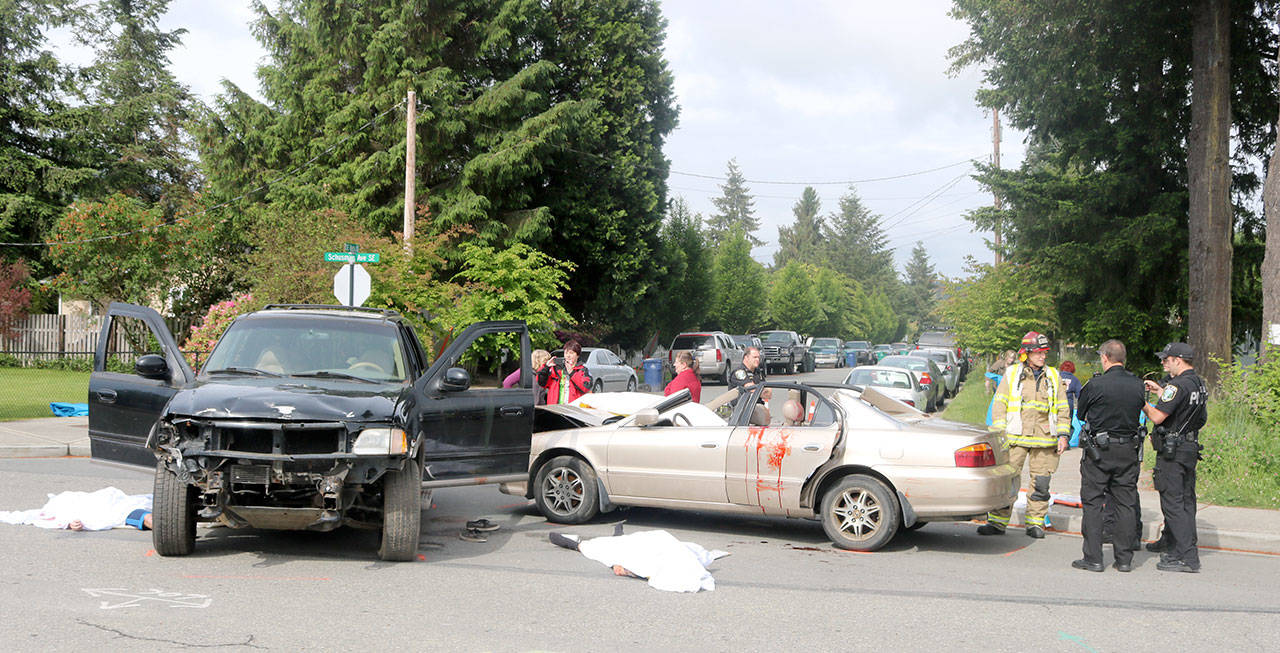 Two damaged cars were parked outside Mount Si High School as the set of the mock crash. Evan Pappas/Staff Photo