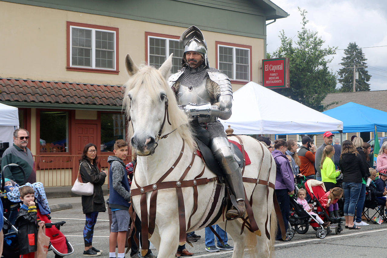 A knight, part of the Society for Creative Anachronism, rides by in the Fall City Day Parade. Evan Pappas/Staff Photo