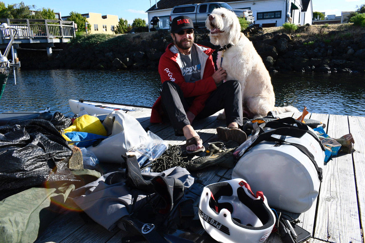 R2AK entrant Josh Collins of Merritt Island, Fla., is Team Torrant, a stand-up paddleboarder who plans to go all the way to Ketchikan while raising awareness of traumatic brain injuries and PTSD in veterans. Collins is with his therapy dog Charlie who won’t be going along for the ride. The race begins Thursday at 5 a.m. from the Port Townsend waterfront. (Jeannie McMacken/Peninsula Daily News)