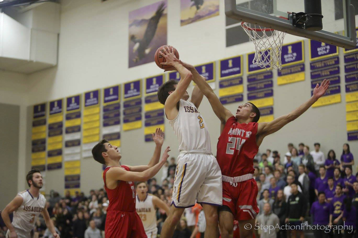 Mount Si Wildcats player Bijon Sidhu, right, tries to block a shot against Issaquah forward Will Farmer in a KingCo 4A contest between rivals on Jan. 5. The Wildcats finished the 2017-18 season with an overall record of 13-11.                                Photo courtesy of Don Borin/Stop Action Photography