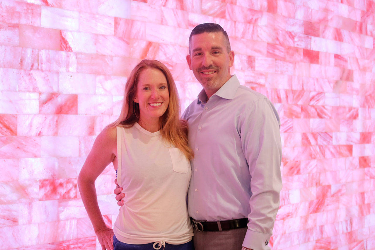 Pineapple Life owners Brandi and Brian Cohen standing in the main yoga room in front of the Himalayan Salt Rock wall. Evan Pappas/staff photo