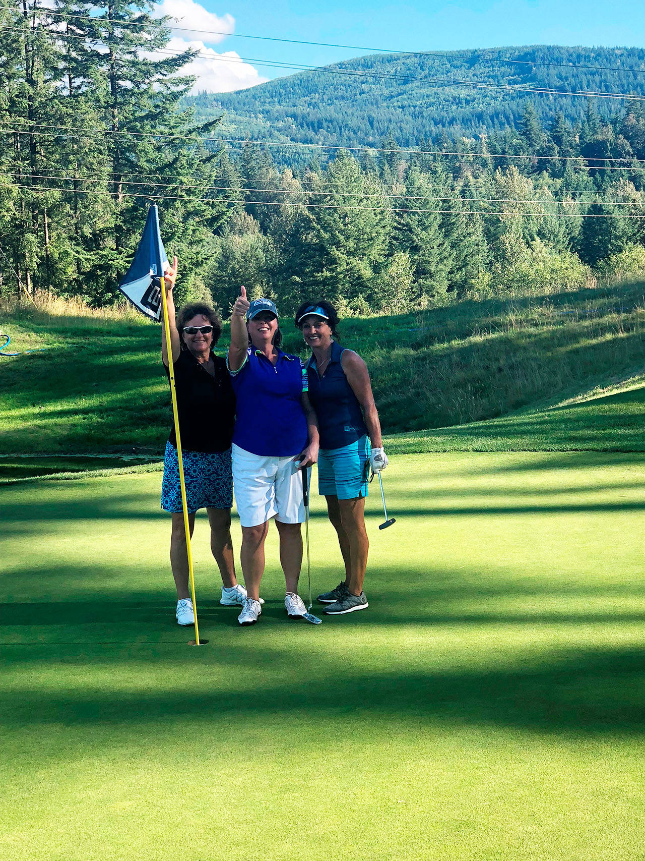 From left, Julie Meador, Tina Methven and Annette Seydel following Methven’s hole-in-one on July 10. Courtesy photo