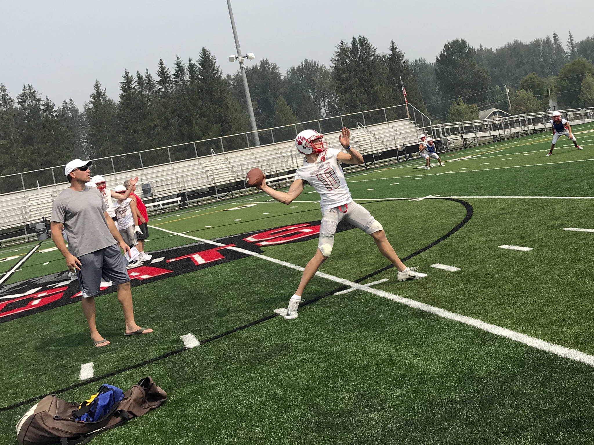 Mount Si Wildcats senior quarterback Cale Millen, center, unleashes pass deep down the right sideline on the first day of practice on Aug. 15. Millen will play college football at the University of Oregon next year. Shaun Scott/staff photo