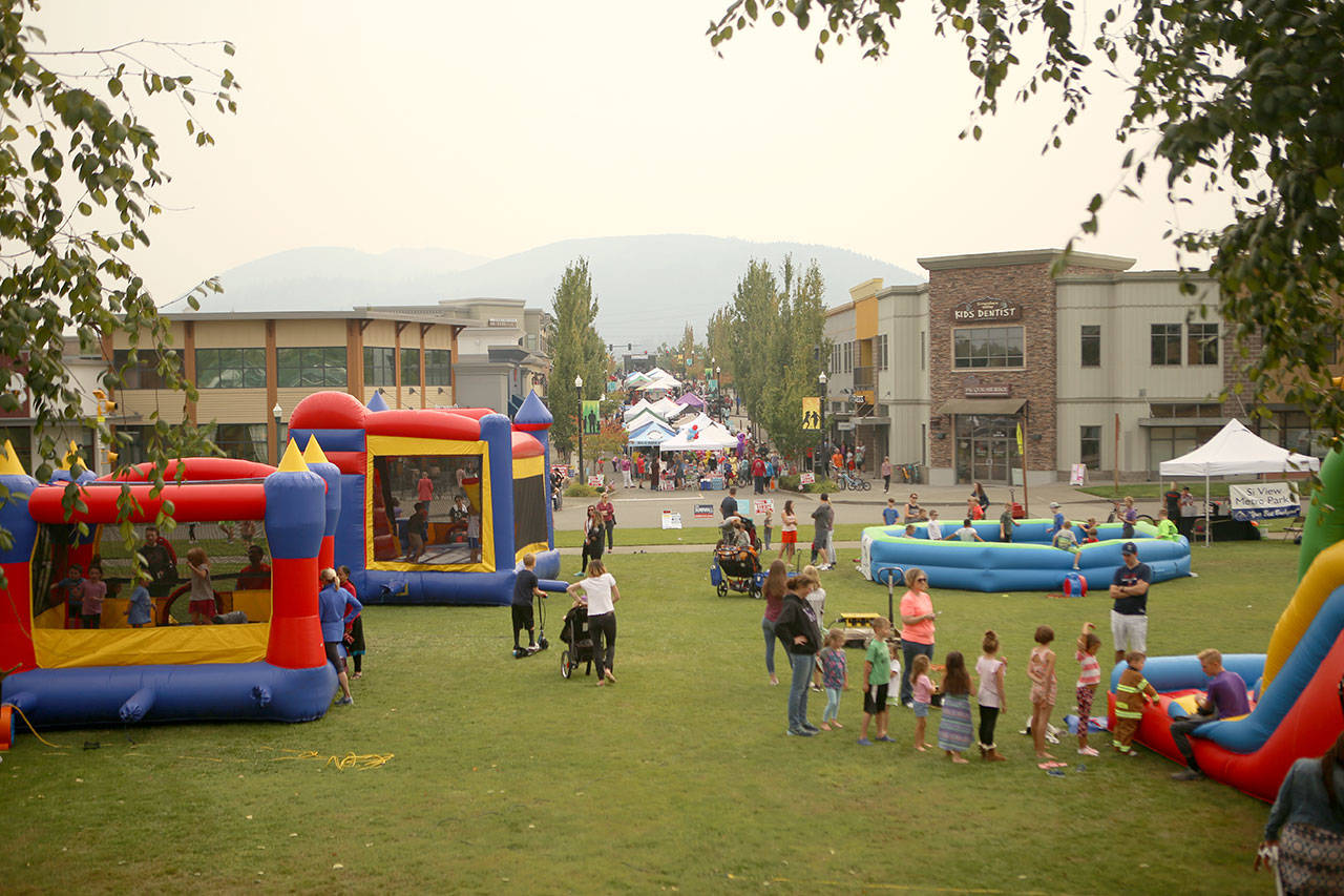 Community Park was filled with games and bounce houses for kids, while Center Boulevard SE had booths featuring various local organizations. (Joe Dockery/Courtesy Photo)
