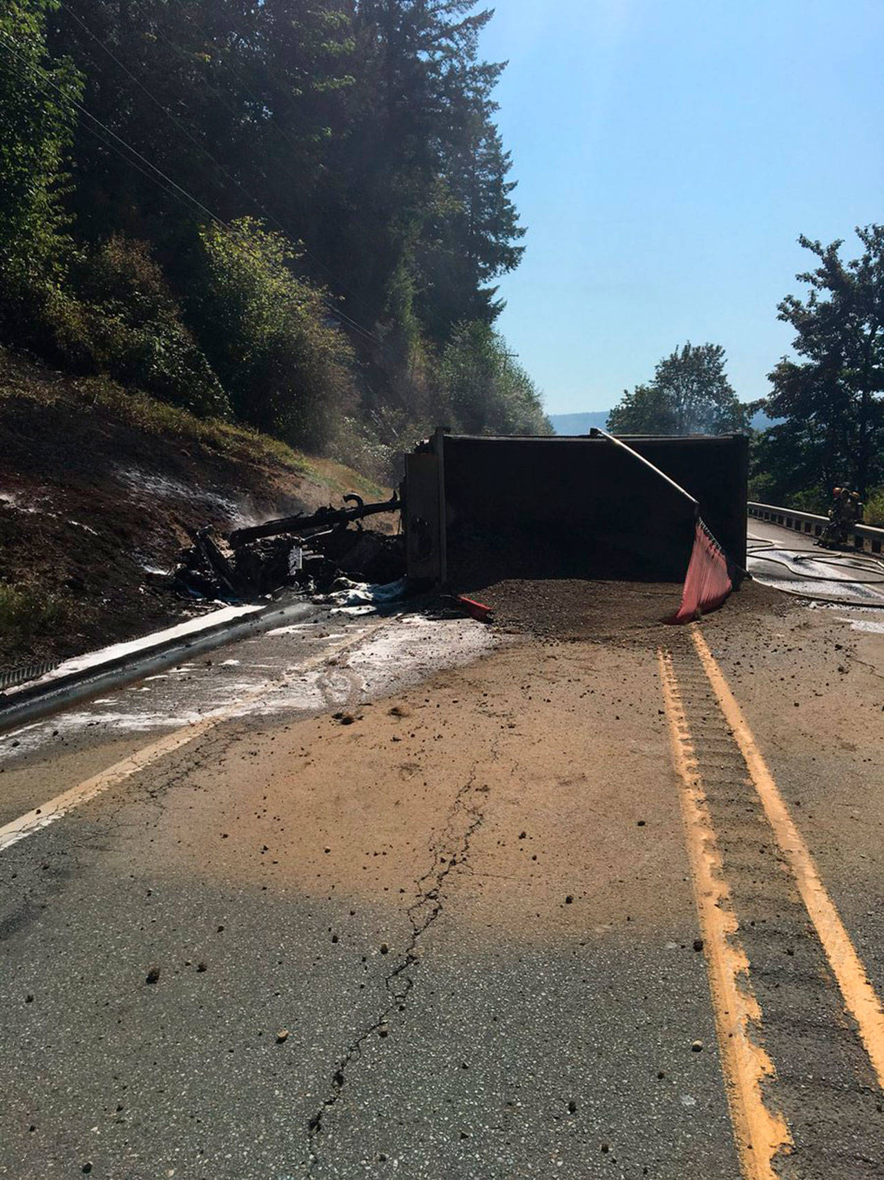 The dump truck was engulfed in flames when first responders arrived on the scene. Photos courtesy of Washington State Patrol Trooper Rick Johnson