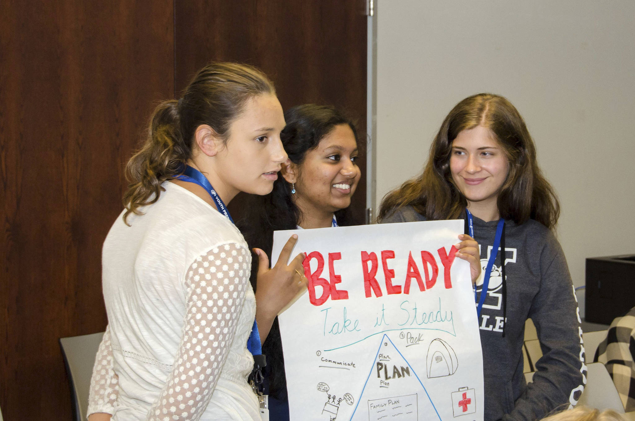 (Right to left) Gabrielle Karber, Ritusha Samal and Teagan Grabish show off the disaster preparedness poster their group developed as part of a short activity at FEMA. Photo courtesy of FEMA Region 10, Jeffrey Markham