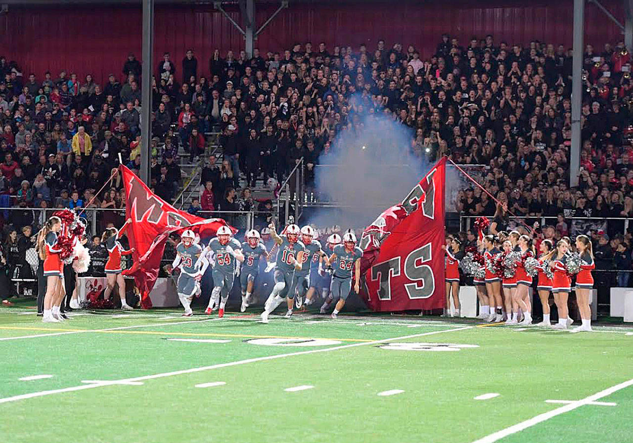 Mount Si football team charging into the Homecoming game. Photo courtesy of Calder Productions.