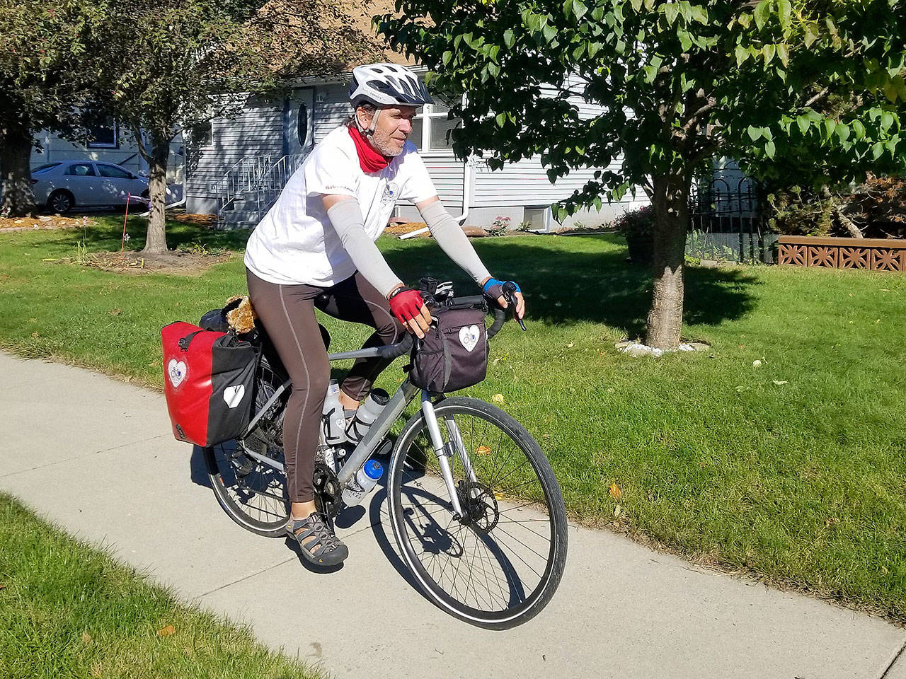 Kirk Gillock of North Bend on his 4,233 mile cycle tour across 13 states to spread the message of love, unity and balance. Photo courtesy of Kirk Gillock.