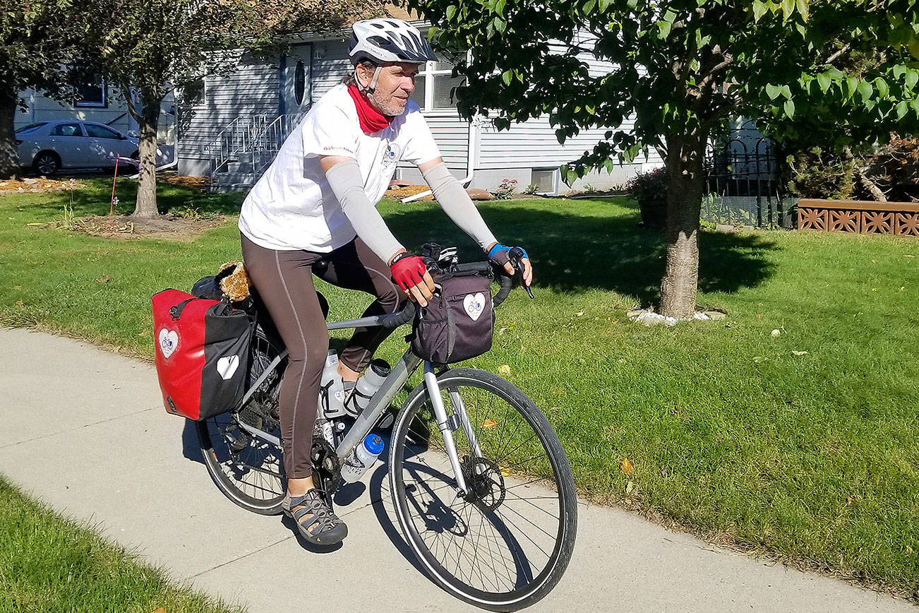 Kirk Gillock of North Bend on his 4,233 mile cycle tour across 13 states to spread the message of love, unity and balance. Photo courtesy of Kirk Gillock.
