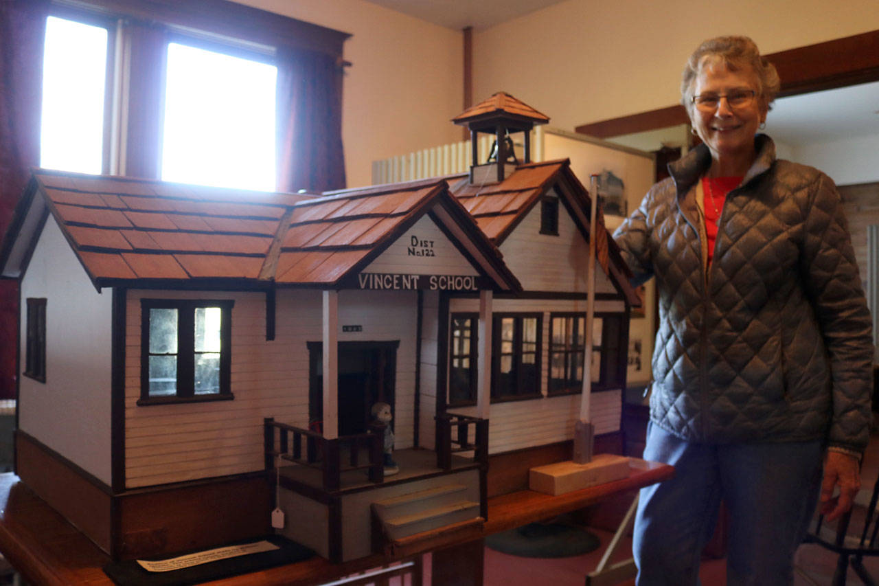 Jackie Norris stands with the miniature replica of the Vincent Schoolhouse made by William Quaale. The schoolhouse was built in 1905 and closed in 1942. Evan Pappas/Staff Photo