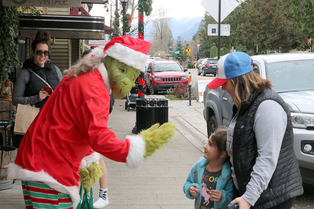 Four-year-old Audrey meets The Grinch outside of Wild Hare Vintage on Railroad Avenue in Snoqualmie. Evan Pappas/Staff Photo