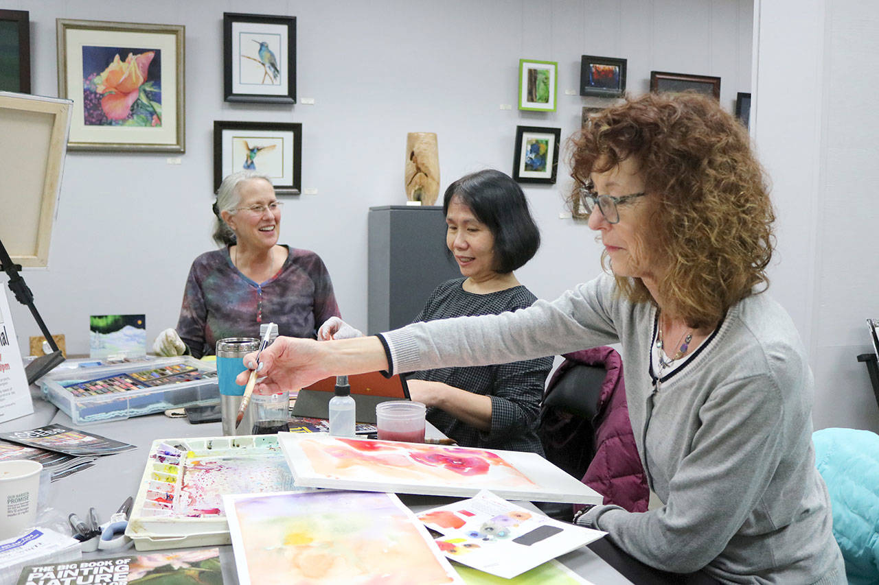 Local artists Laurie Clark, Minh Rosen, and Cece Williams work on their art projects while discussing technique. Evan Pappas/Staff Photo