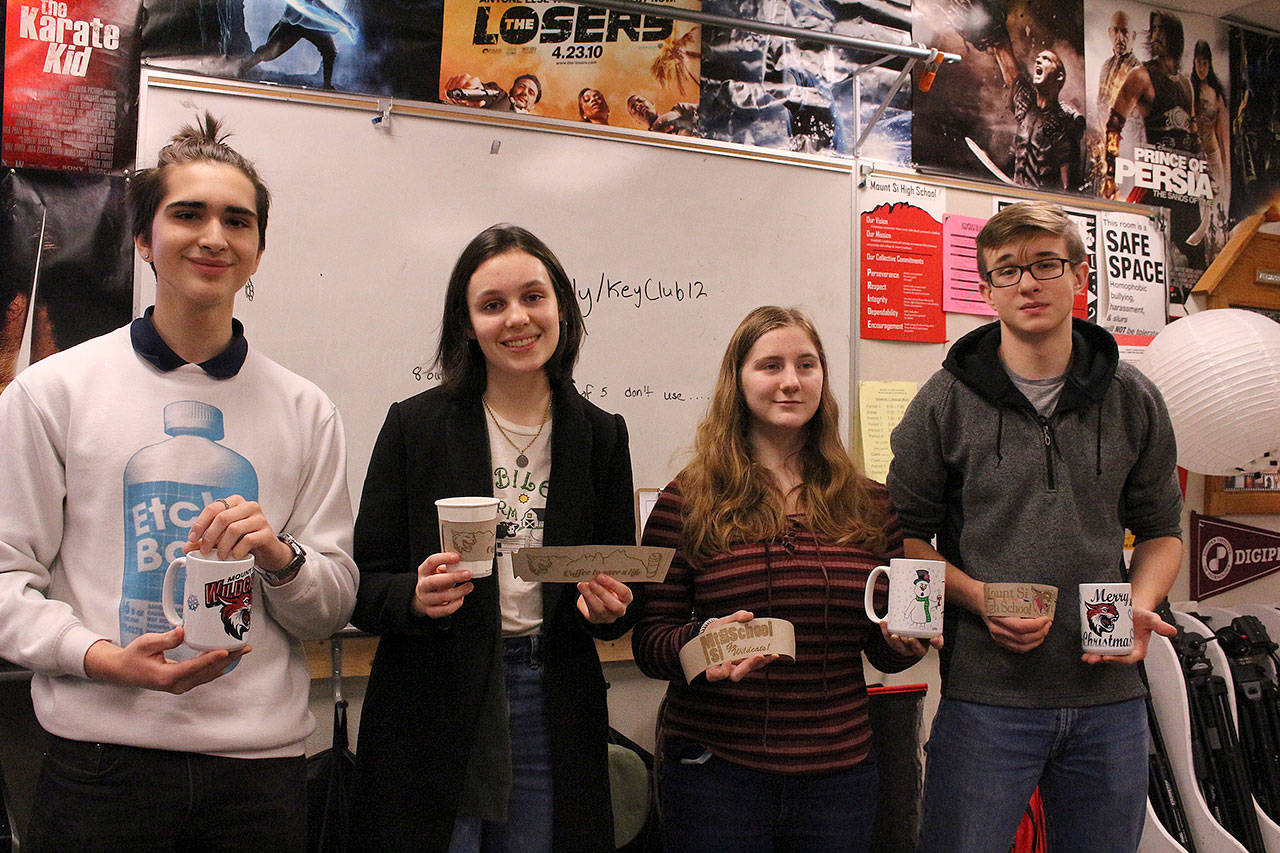 From left: Maximo Jimenez, Cameron McCrea, Rowen Higgins and Ivan Dyshlevich. Joe Dockery’s digital media class create and sell coffee mugs and sleeves to support the school’s suicide prevention program. Madison Miller/staff photo