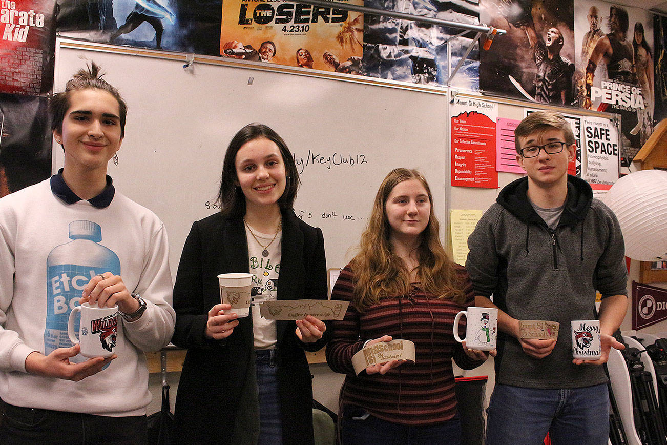 From left: Maximo Jimenez, Cameron McCrea, Rowen Higgins and Ivan Dyshlevich. Joe Dockery’s digital media class create and sell coffee mugs and sleeves to support the school’s suicide prevention program. Madison Miller/staff photo