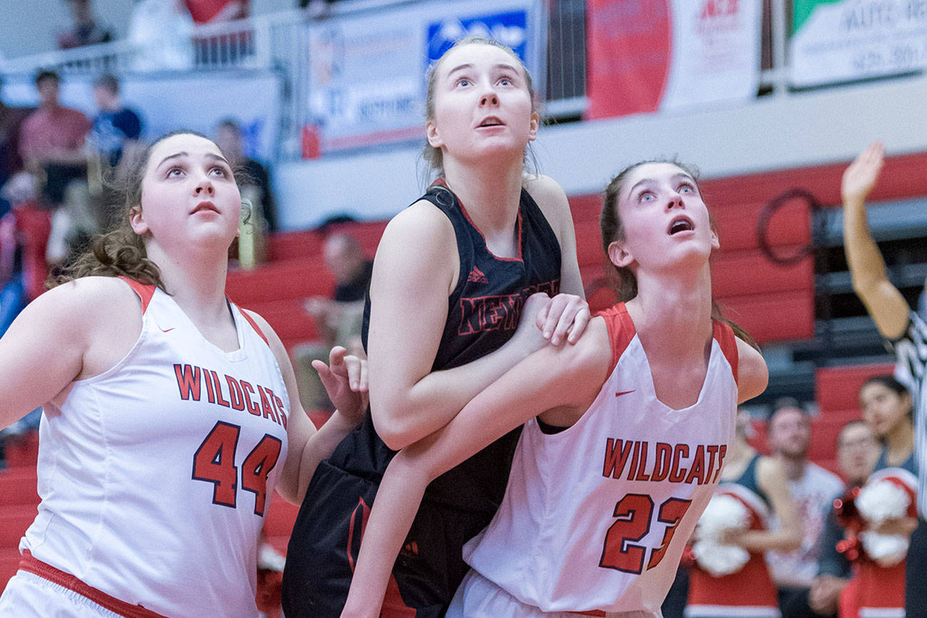Mount Si Wildcats freshman Lauren Glazier, right, and senior Abigail Triou, left, box out a Newport player during a matchup on senior night on Jan. 16 in Snoqualmie. Photo courtesy of Patrick Krohn/Patrick Krohn Photography