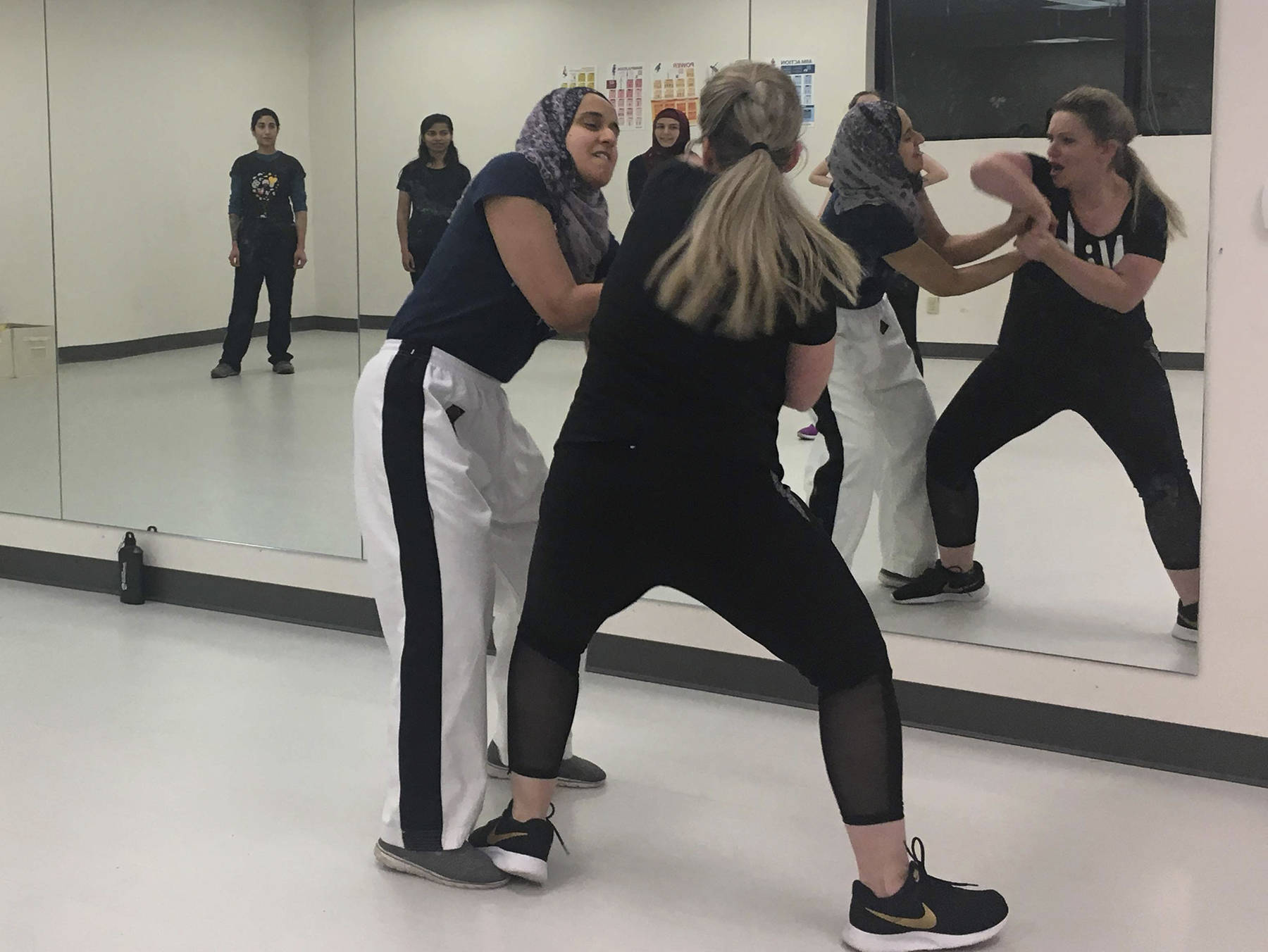 ‘Defense Ninjas’ instructor Fauzia Lala and COO Kate Warady demonstrate how to break a wrist grab in a workout room at Redmond’s DaVinci Academy on Jan. 15. Katie Metzger/staff photo