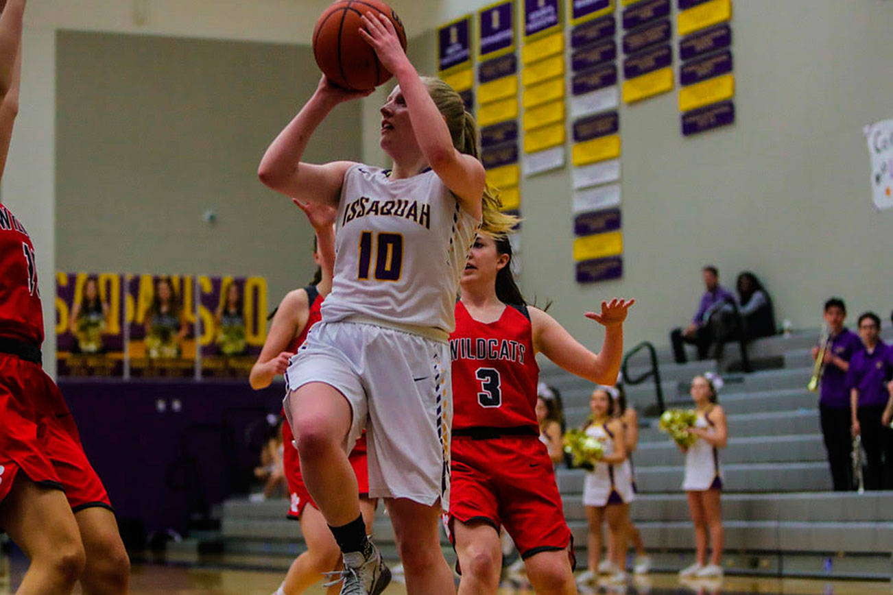 Mount Si Wildcats junior guard Carly Britton, right, tries to chase down Issaquah senior Luci Stewart, center, in a matchup between rivals on Jan. 25 in Issaquah. Issaquah defeated Mount Si 55-23. Photo courtesy of Don Borin/Stop Action Photography