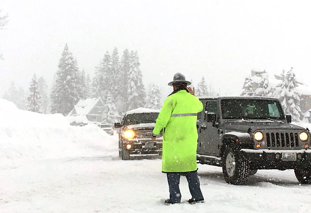 Captain Ron Mead, commander of the Washington State Patrol in King County, directs traffic on the top of Snoqualmie Pass. Photo courtesy of Trooper Rick Johnson.