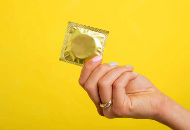 Woman holding a condom. Photo courtesy istockphoto.com