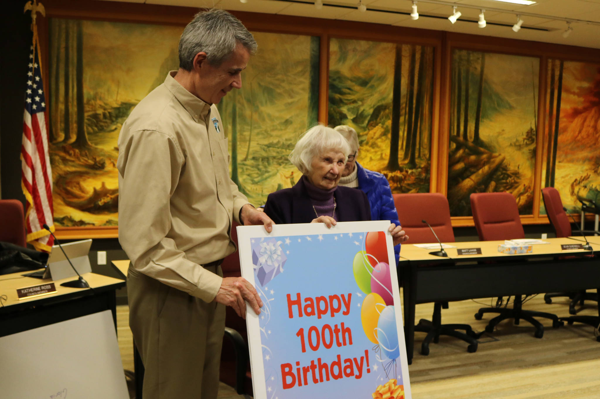Gloria McNeely was presented with a large card as part of her 100th birthday celebration at city all on Feb. 25. Evan Pappas/Staff Photo