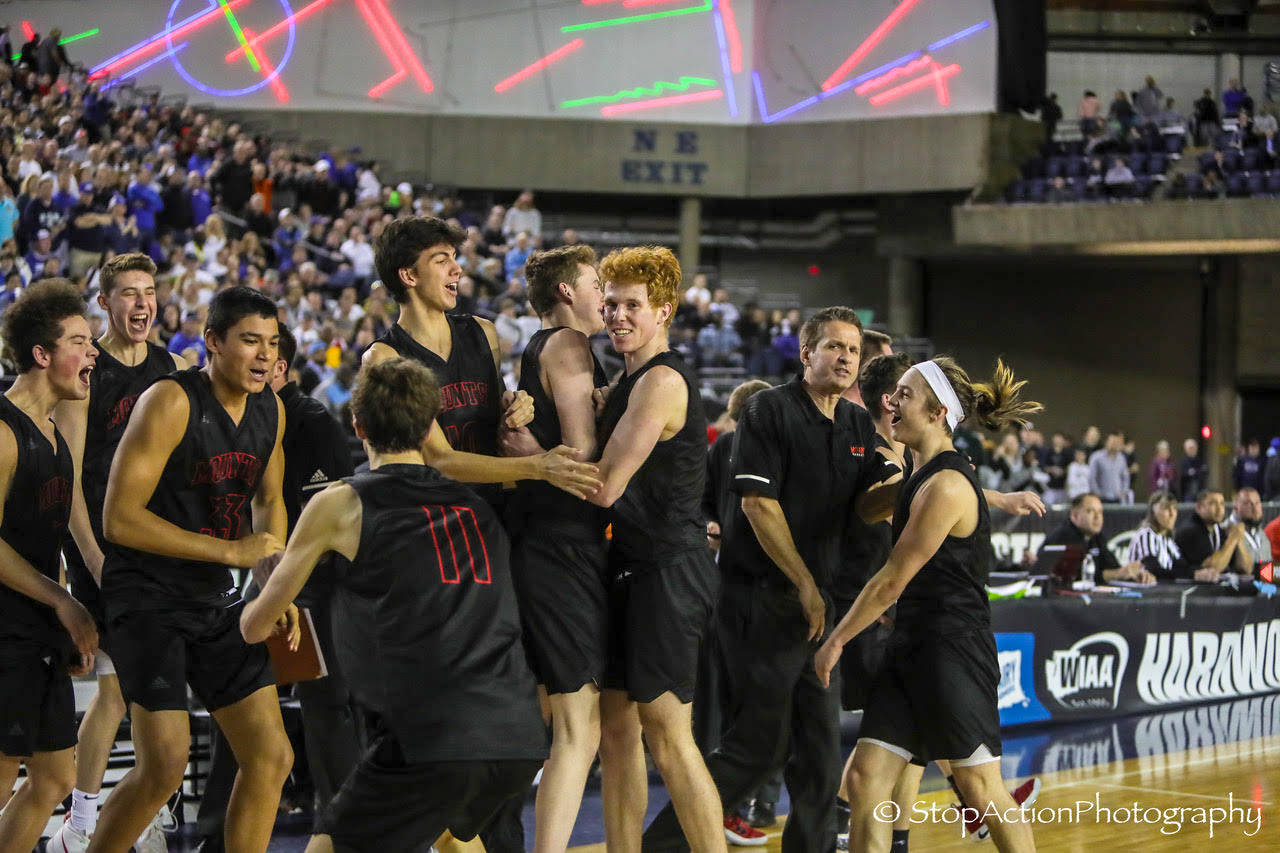 Mount Si Wildcats celebrate along the bench just seconds following the final buzzer in the Class 4A state semifinals. Mount Si defeated the Curtis Vikings 53-46 in the Class 4A state semifinals on March 1 at the Tacoma Dome. Photo courtesy of Don Borin/Stop Action Photography