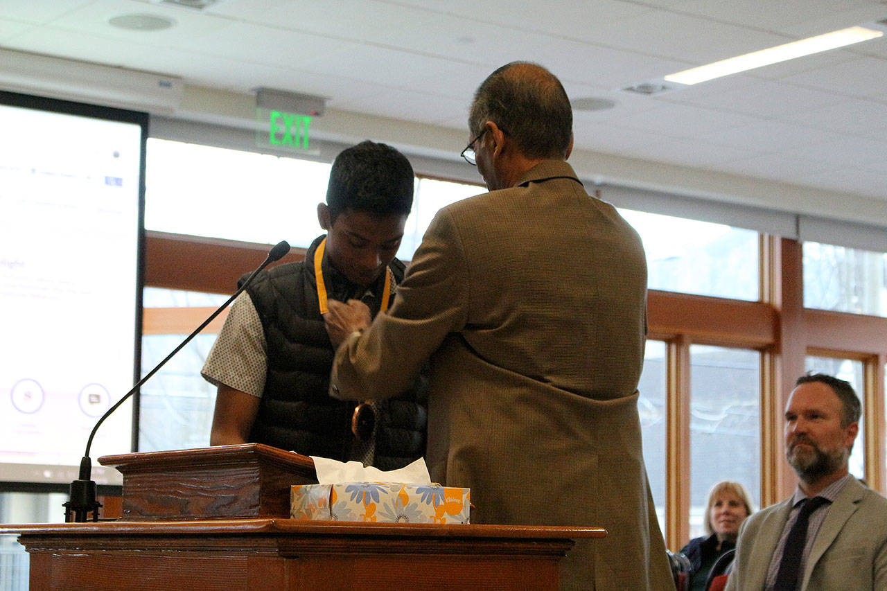 Chirag Vedullapalli receives a bronze medallion for his nonprofit work by Abraham Mathan of Prudential Financial. Madison Miller / staff photo