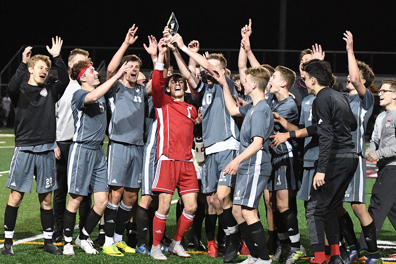 The Mount Si Wildcats boys soccer team hoists the 4A KingCo championship trophy following their victory against the Issaquah Eagles on April 30. Photo courtesy of Calder Productions