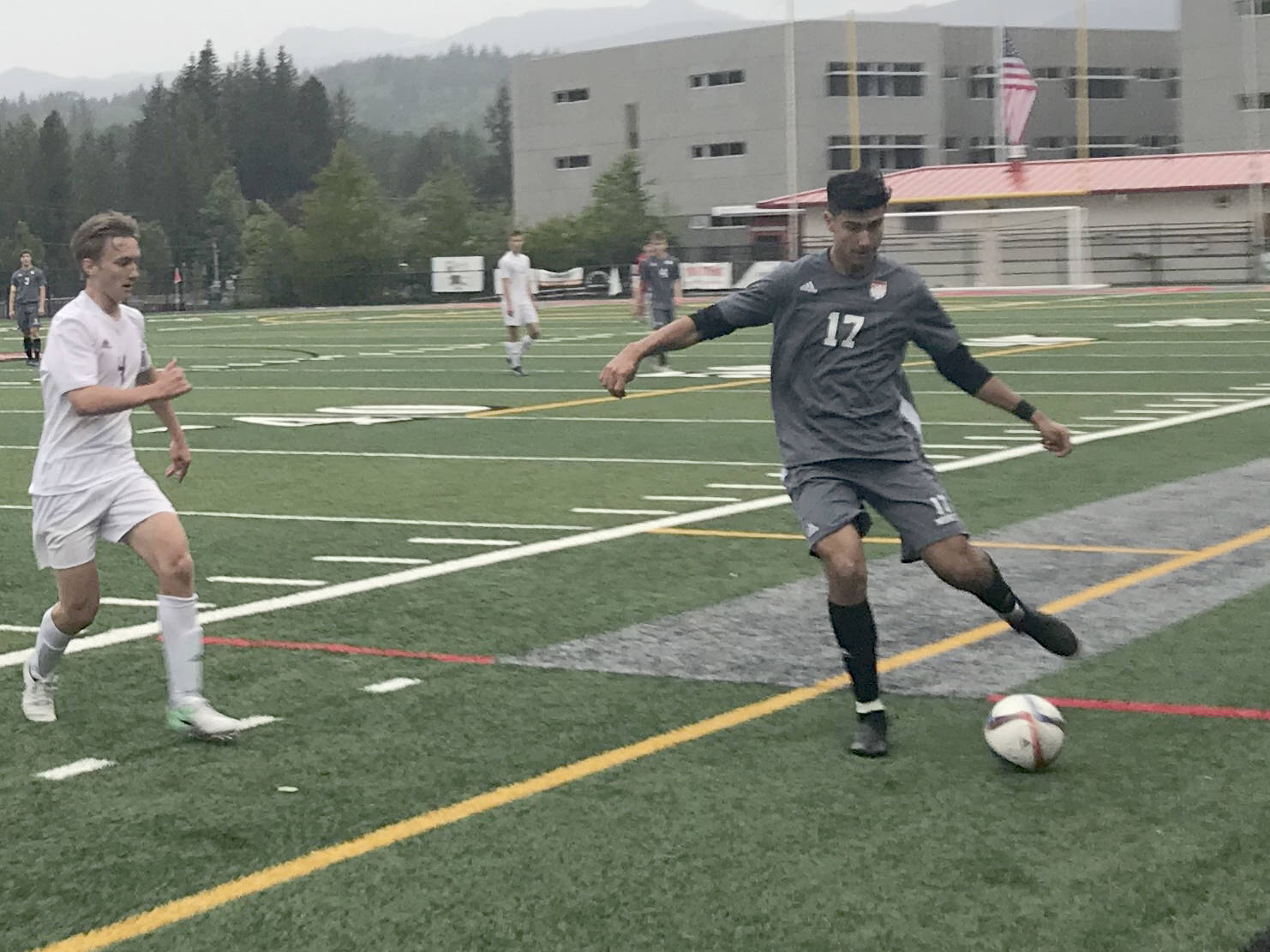 Mount Si junior defender Jake Jimenez, right, passes the ball up field to a teammate in the first half of play against the Sumner Spartans. Mount Si defeated Sumner 2-1 in the first round of the 4A state playoffs on May 15 at Mount Si High School in Snoqualmie. Shaun Scott/staff photo