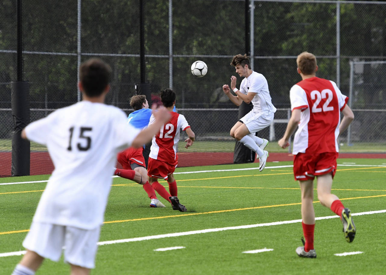Mount Si senior Drew Harris, right, scores on a header during the 4A state semifinals. Photo courtesy of Calder Productions