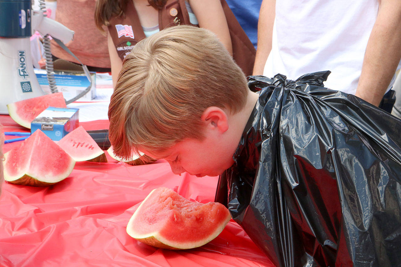 Lucas Sax of Fall City starts strong in the 5-7 year old category of the annual watermelon eating contest. Evan Pappas/Staff Photo