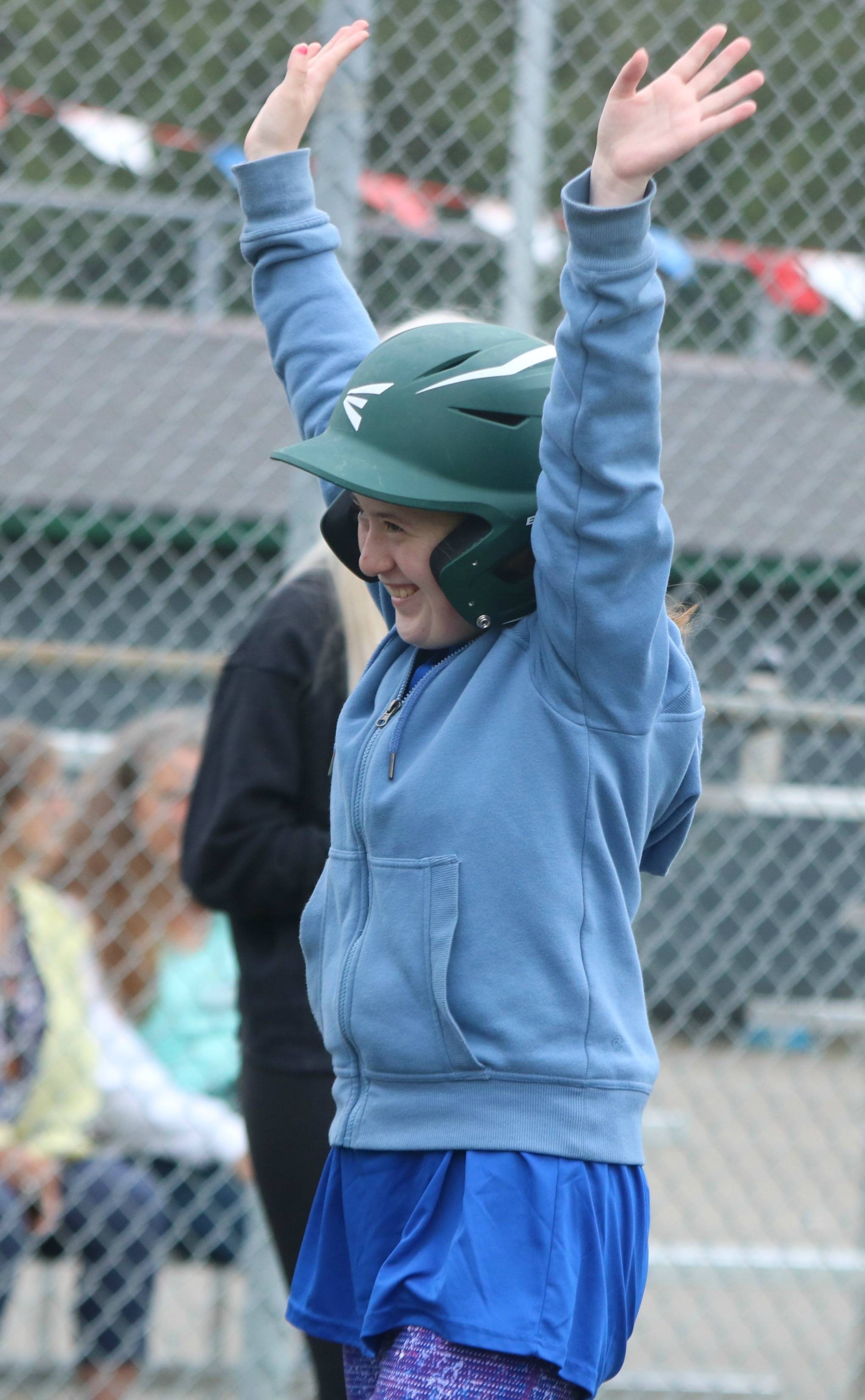 April Snow celebrates scoring after running the bases with team Snoqualmie parent Brandon Duffy. Andy Nystrom / staff photo