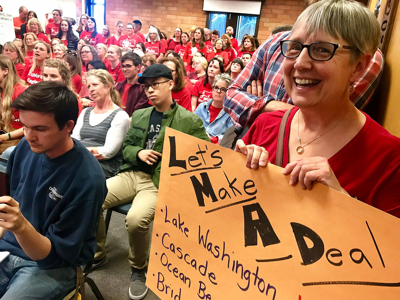 Mukilteo School District teachers urge elected officials to renegotiate their salaries at a school board meeting back in June 2018. On Monday, they got a deal they like. (Andrea Brown / Herald file)