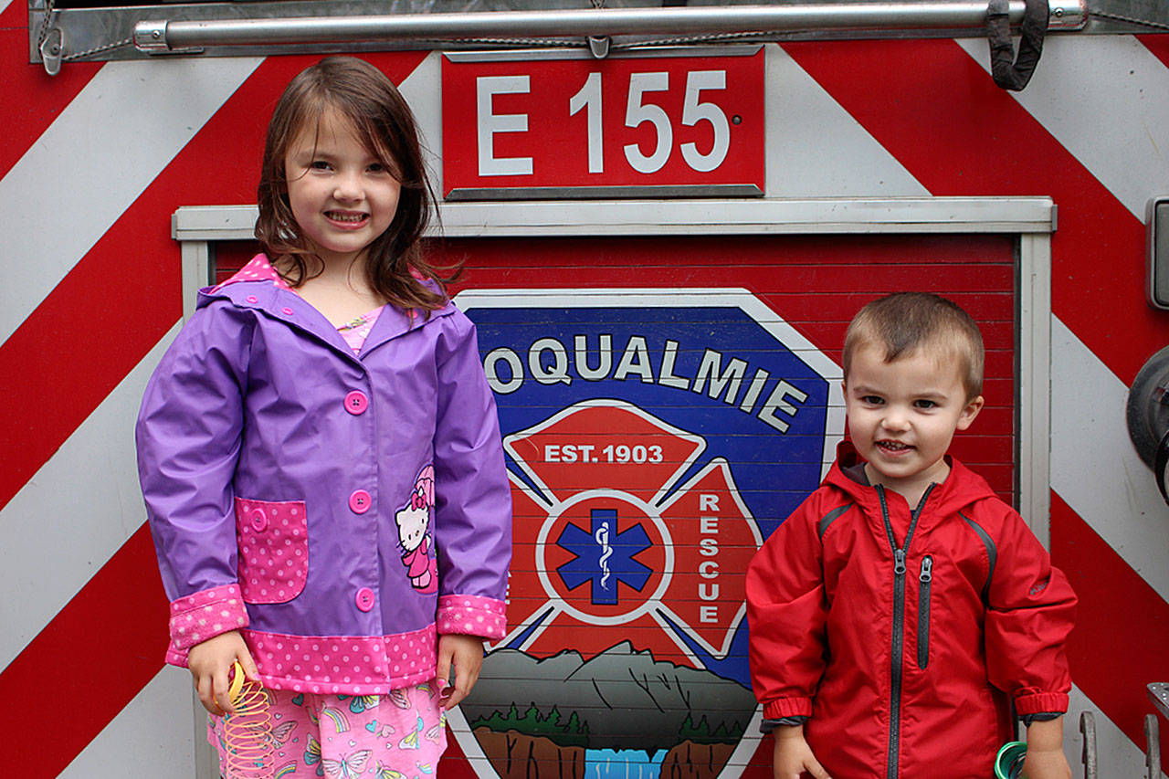 6-year-old Finley Gendron (left) and her little brother, Boston Gendron, explore the city’s fire truck during Big Truck Day. Madison Miller / staff photo