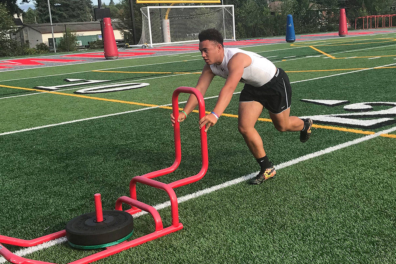 Mount Si Wildcats running back Cole Norah pushes a sled during the Wildcats speed and agility camp on July 23 at Mount Si High School in Snoqualmie. Shaun Scott/staff photo